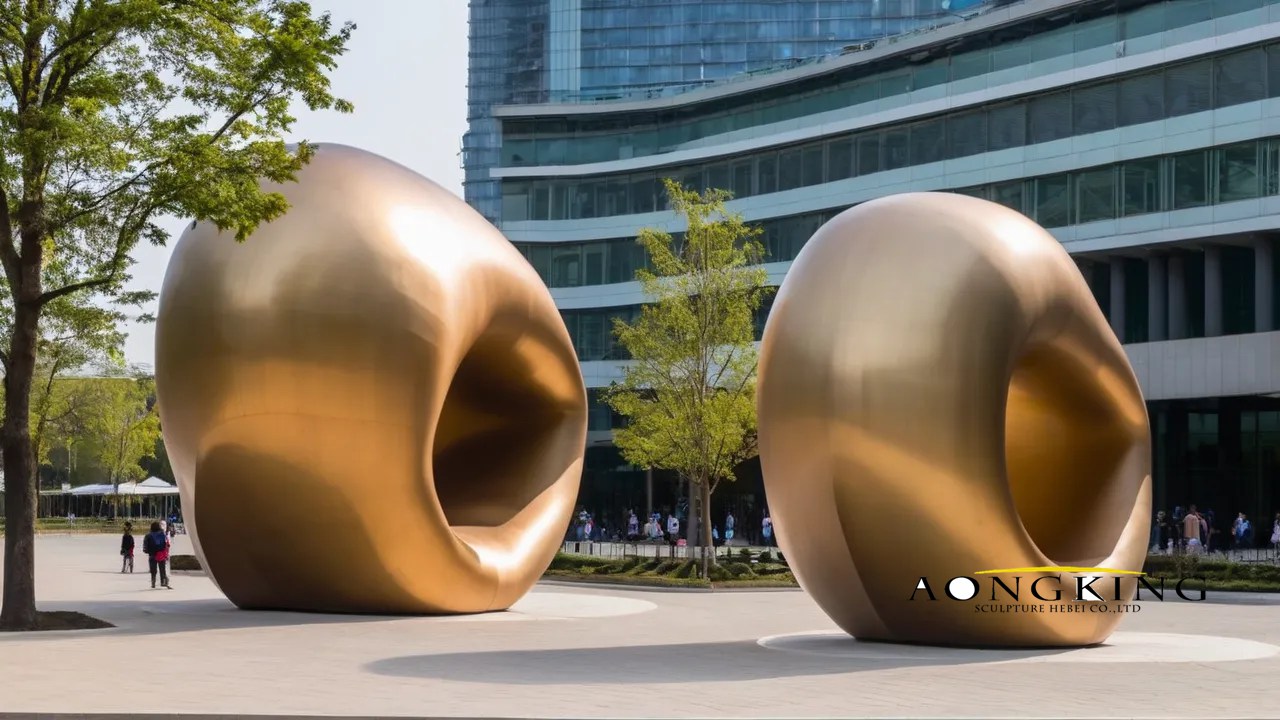 Massive hollow structure with golden spray paint commissioned art "ring balloon"stainless steel sculpture
